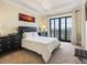 Comfortable bedroom featuring black furnishings, sunset artwork, and balcony doors at 88 W Paces Ferry # 2230, Atlanta, GA 30305