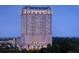 Luxury high-rise condo building featuring distinctive architectural details and stunning views at dusk at 88 W Paces Ferry # 2230, Atlanta, GA 30305