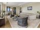 Bright living room featuring a curved sofa, sleek furnishings, and balcony access at 88 W Paces Ferry # 2230, Atlanta, GA 30305
