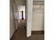 Carpeted hallway featuring a closet and an open doorway leading to other areas of the home at 102 Governors Dr, Forest Park, GA 30297
