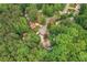 An aerial view of a home nestled among lush trees, offering a sense of privacy and a glimpse of the neighborhood at 204 Queensbury Ct, Acworth, GA 30102