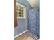This renovated bathroom has a modern vanity and custom shower with stylish shower curtain at 204 Queensbury Ct, Acworth, GA 30102