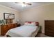 The quaint bedroom includes a comfortable bed with soft white linens at 204 Queensbury Ct, Acworth, GA 30102