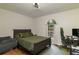 Bedroom with hardwood floors, dark wood bed frame, and modern light fixture at 204 Queensbury Ct, Acworth, GA 30102