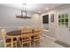 Cozy dining room with wood-look tile floors, modern lighting, and ample seating at 204 Queensbury Ct, Acworth, GA 30102