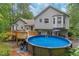 Backyard exterior with a multi-level deck and an inviting above-ground pool at 204 Queensbury Ct, Acworth, GA 30102