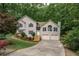 Charming home with manicured lawn, beautiful landscaping, and a two-car garage at 204 Queensbury Ct, Acworth, GA 30102
