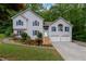 Charming home with manicured lawn, beautiful landscaping, and a two-car garage at 204 Queensbury Ct, Acworth, GA 30102