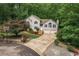 Two-story home with lush landscaping, two-car garage, and large driveway at 204 Queensbury Ct, Acworth, GA 30102