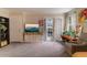 The sun-filled living room boasts neutral walls, lots of natural light, and patio access at 204 Queensbury Ct, Acworth, GA 30102