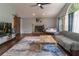 Spacious living room with a fireplace, ceiling fan, and beautiful hardwood floors at 204 Queensbury Ct, Acworth, GA 30102