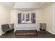 Bedroom with tray ceiling, hardwood floors and comfortable furnishings at 204 Queensbury Ct, Acworth, GA 30102
