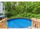 Above ground pool with surrounding trees, creating a private oasis for relaxation at 204 Queensbury Ct, Acworth, GA 30102