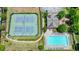 Aerial view of tennis courts, clubhouse, and a large swimming pool in a residential community at 2093 Callaway Nw Ct, Atlanta, GA 30318