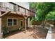 Backyard with brick wall, wooden deck, door to basement, and steps leading up to the grassy area at 2093 Callaway Nw Ct, Atlanta, GA 30318