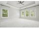 Spacious bedroom with tray ceilings, neutral carpet, and large windows for ample natural light at 2093 Callaway Nw Ct, Atlanta, GA 30318