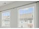 Bright bedroom featuring two windows with blinds providing views of neighborhood at 2093 Callaway Nw Ct, Atlanta, GA 30318
