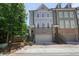 Beautiful townhome features brick facade, grey siding, a garage and street parking at 2093 Callaway Nw Ct, Atlanta, GA 30318