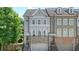 Charming townhome with gray and brick exterior, front-entry garage, and well-maintained landscaping at 2093 Callaway Nw Ct, Atlanta, GA 30318