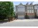 Beautiful townhome features brick facade, grey siding, a garage and street parking at 2093 Callaway Nw Ct, Atlanta, GA 30318