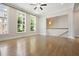Spacious living room with hardwood floors, ceiling fan, recessed lighting and large windows with decorative curtains at 2093 Callaway Nw Ct, Atlanta, GA 30318