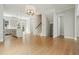 Spacious living room featuring hardwood floors, modern lighting, and open access to the kitchen and staircase at 2093 Callaway Nw Ct, Atlanta, GA 30318
