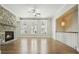 Living room featuring hardwood floors, fireplace, windows, and open connection to the upstairs area at 2093 Callaway Nw Ct, Atlanta, GA 30318