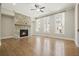 Bright living room with hardwood floors, a stone fireplace, and large windows offering ample natural light at 2093 Callaway Nw Ct, Atlanta, GA 30318