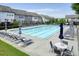 Community pool with lounge chairs and umbrellas on the deck at 2093 Callaway Nw Ct, Atlanta, GA 30318