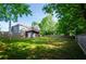 Spacious backyard featuring a two-story home with a deck, enclosed by a wooden fence at 219 Brick Mill Dr, Canton, GA 30115