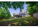 Two-story home's backyard boasts a spacious lawn, deck and walkout basement; embraced by mature trees at 219 Brick Mill Dr, Canton, GA 30115