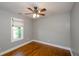 Bedroom features hardwood floors, a ceiling fan, and a window with natural light at 219 Brick Mill Dr, Canton, GA 30115
