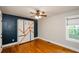 Bedroom features hardwood floors, murphy bed, window, and modern lighting at 219 Brick Mill Dr, Canton, GA 30115