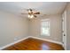 Cozy bedroom features hardwood floors, a ceiling fan, and a window with natural light at 219 Brick Mill Dr, Canton, GA 30115