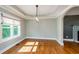 Dining room featuring hardwood floors, ample light, and open access to living area at 219 Brick Mill Dr, Canton, GA 30115