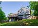 Exterior view showcases a two-story house with a walkout basement and a deck, enveloped by lush greenery at 219 Brick Mill Dr, Canton, GA 30115