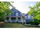 Charming two-story home featuring blue siding and a welcoming front porch at 219 Brick Mill Dr, Canton, GA 30115