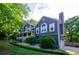 Front exterior of a two-story home with manicured landscaping, a covered porch, and an attached garage at 219 Brick Mill Dr, Canton, GA 30115