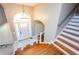 Inviting foyer featuring a staircase, unique tile, and a charming arched doorway at 219 Brick Mill Dr, Canton, GA 30115