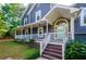 Close-up of the inviting front porch with stone accents and a light green front door at 219 Brick Mill Dr, Canton, GA 30115