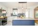 Bright kitchen features a center island, granite countertops, and stylish lighting fixtures at 219 Brick Mill Dr, Canton, GA 30115