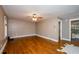 Spacious living room with hardwood floors and ceiling fan lighting leads to an updated bathroom at 219 Brick Mill Dr, Canton, GA 30115