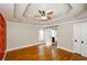 Primary bedroom features beautiful hardwood floors, tray ceiling, and barn door to ensuite bathroom at 219 Brick Mill Dr, Canton, GA 30115