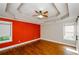 Spacious primary bedroom boasts hardwood floors, tray ceiling, decorative wall and natural light from two windows at 219 Brick Mill Dr, Canton, GA 30115