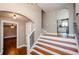 Welcoming foyer featuring hardwood stairs and floors, archways and access to the kitchen and living room at 219 Brick Mill Dr, Canton, GA 30115