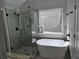 Chic bathroom boasting a soaking tub and glass enclosed shower at 28 Samuel Nw Way, Cartersville, GA 30121