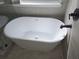 Freestanding white bathtub features black fixtures and tiled gray walls under a window at 28 Samuel Nw Way, Cartersville, GA 30121