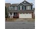 Charming two-story home with blue siding, black shutters, brick accents, and a two-car garage at 28 Samuel Nw Way, Cartersville, GA 30121