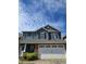 Charming two-story home with blue siding, black shutters, brick accents, and a two-car garage at 28 Samuel Nw Way, Cartersville, GA 30121