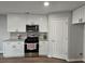 Modern kitchen featuring white cabinets, stainless steel appliances, granite countertops, and grey backsplash at 28 Samuel Nw Way, Cartersville, GA 30121